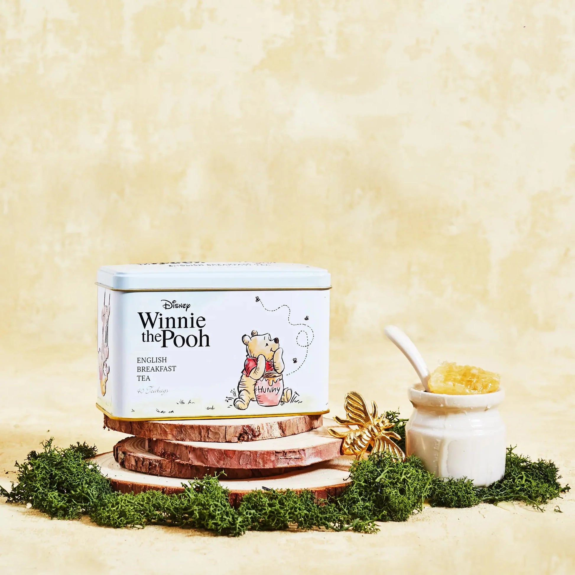 Make an enchanting addition to teatimes with this Disney Winnie the Pooh & Friends Tea Tin. Featuring classic character artwork and familiar Winnie the Pooh scenes, this charming tea tin includes original illustrations and embossed details. Includes