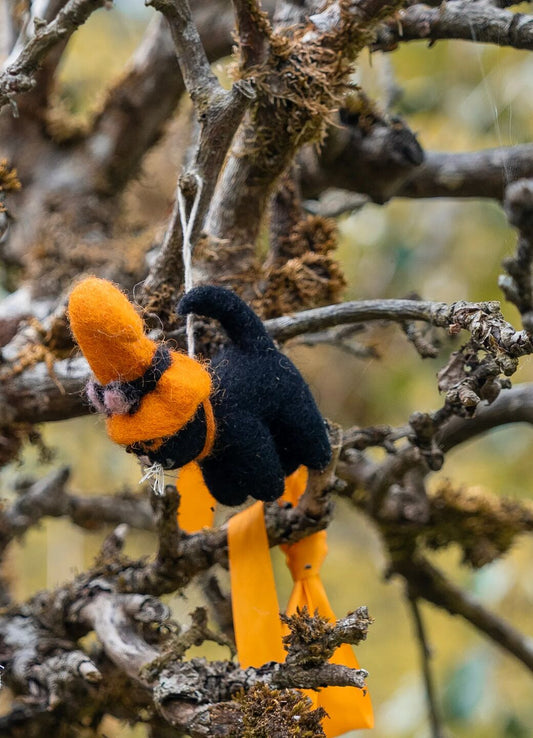Emma Bridgewater Cats are clever animals: they know how to move around stealthily and how to balance on a witchs broomstick, for instance. The cat in this Cat Halloween Felt Decoration is especially clever as he knows that wearing an orange witchs hat 