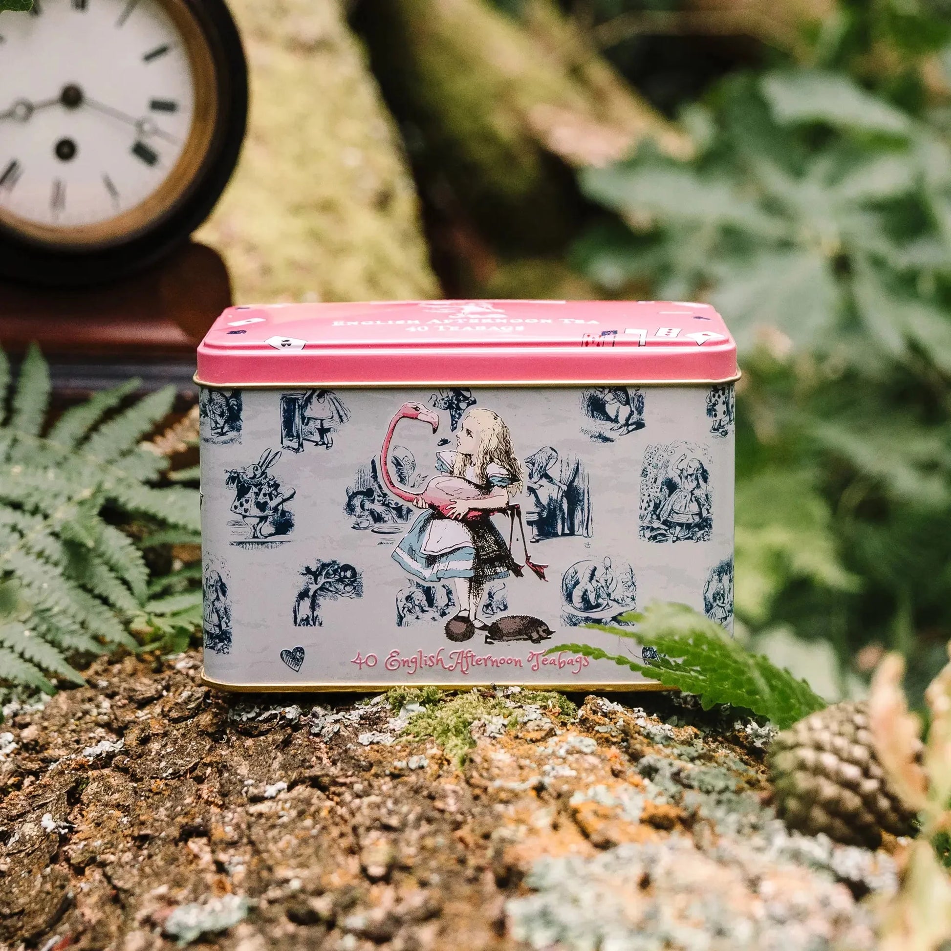 This is no ordinary Tea Tin! Transport yourself down the rabbit hole with this classic Alice In Wonderland Tea Tin. Featuring original illustrations and a vintage-inspired design, this pink and off-white beauty is perfect for any fan of the beloved t