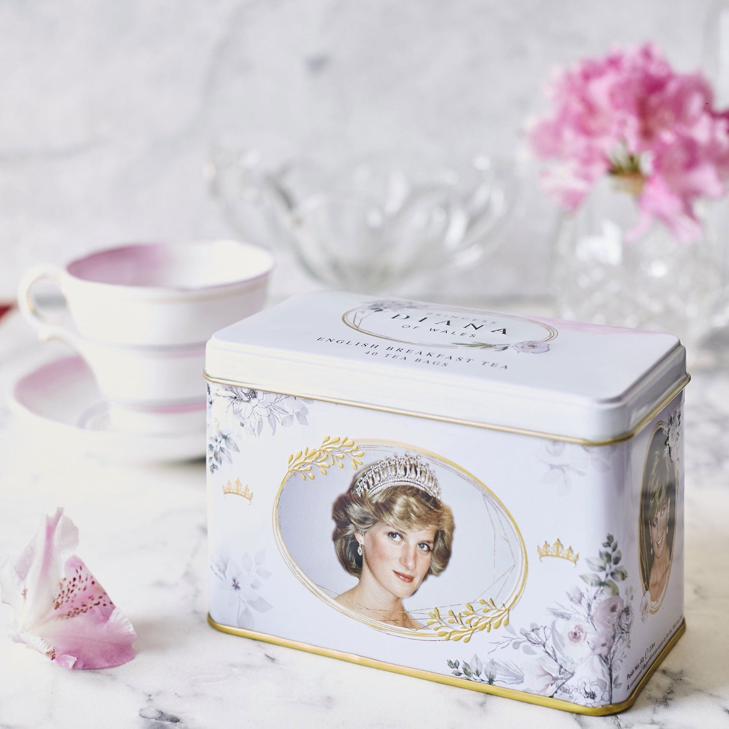 Our very special and commemorative Diana, Princess Of Wales classic tea tin features three iconic images of Diana set on a delicate white floral background with beautiful gold embossing. One of our highly sought after tea tins, this collectable tea t