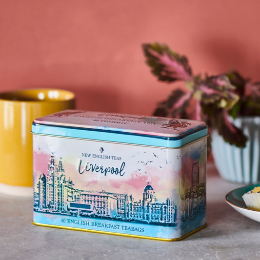 This tea tin features a watercolour print, beautifully capturing Liverpool's waterfront, where the iconic mercantile buildings, known as The Three Graces - The Royal Liver Building, Cunard Building and the Port of Liverpool Building - stand on the Pi