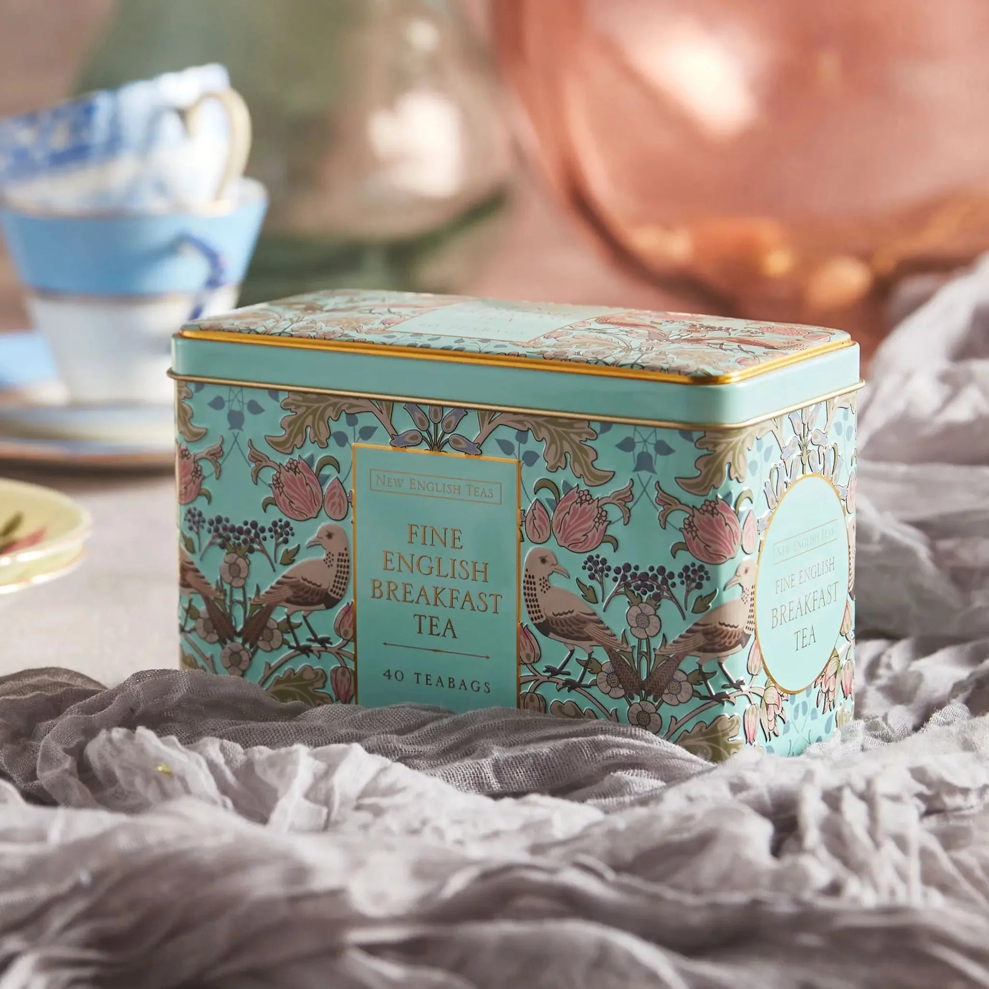 Introducing The Song Thrush and Berries Tea Tin in Mint Green, perfect for tea lovers who appreciate both style and functionality. The tea tin features a stunning William Morris style print pattern that is sure to catch your eye, with intricate detai