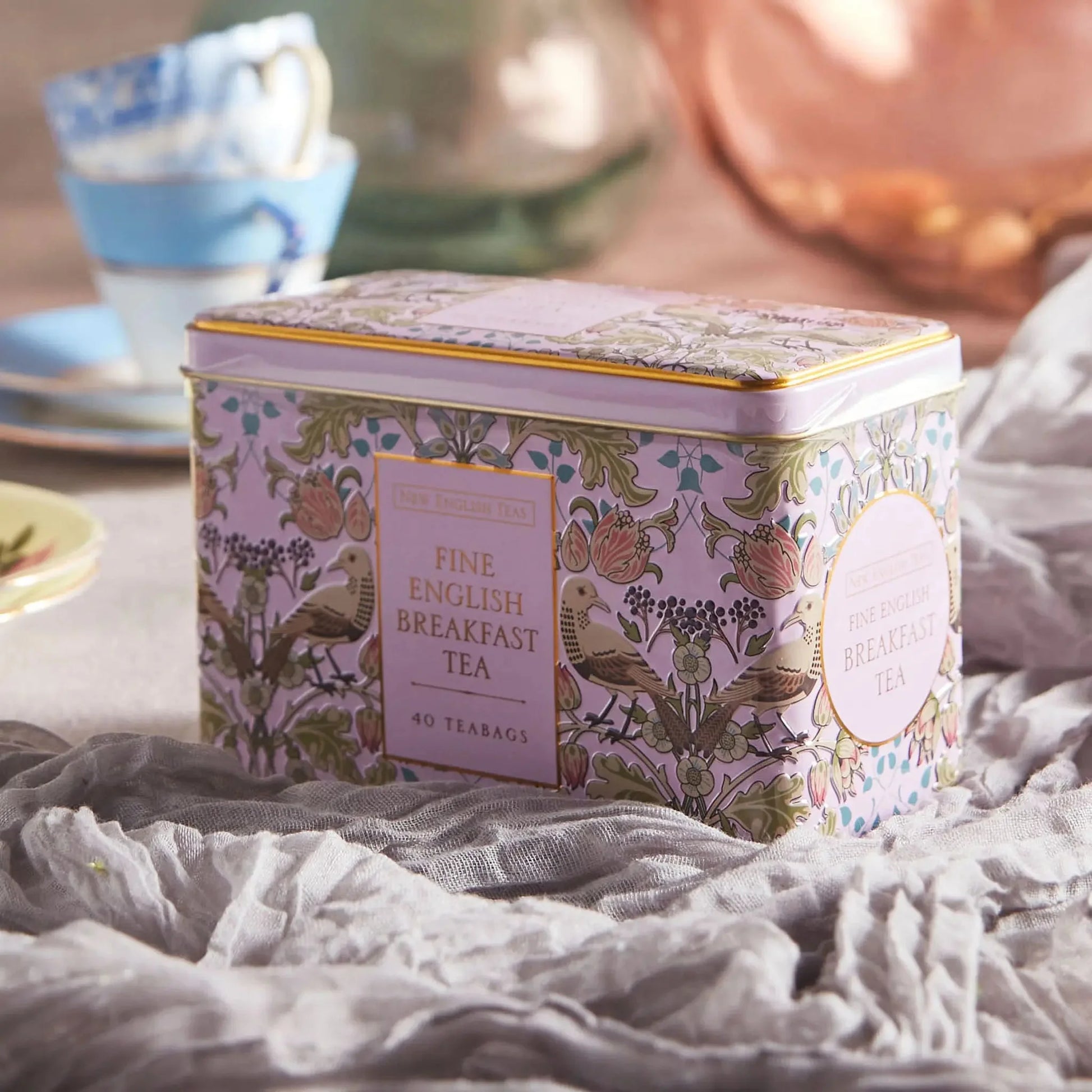 Introducing The Song Thrush and Berries Tea Tin in Pink, perfect for tea lovers who appreciate style and functionality. The tea tin features a stunning William Morris style print pattern that is sure to catch your eye, with intricate embossing and go