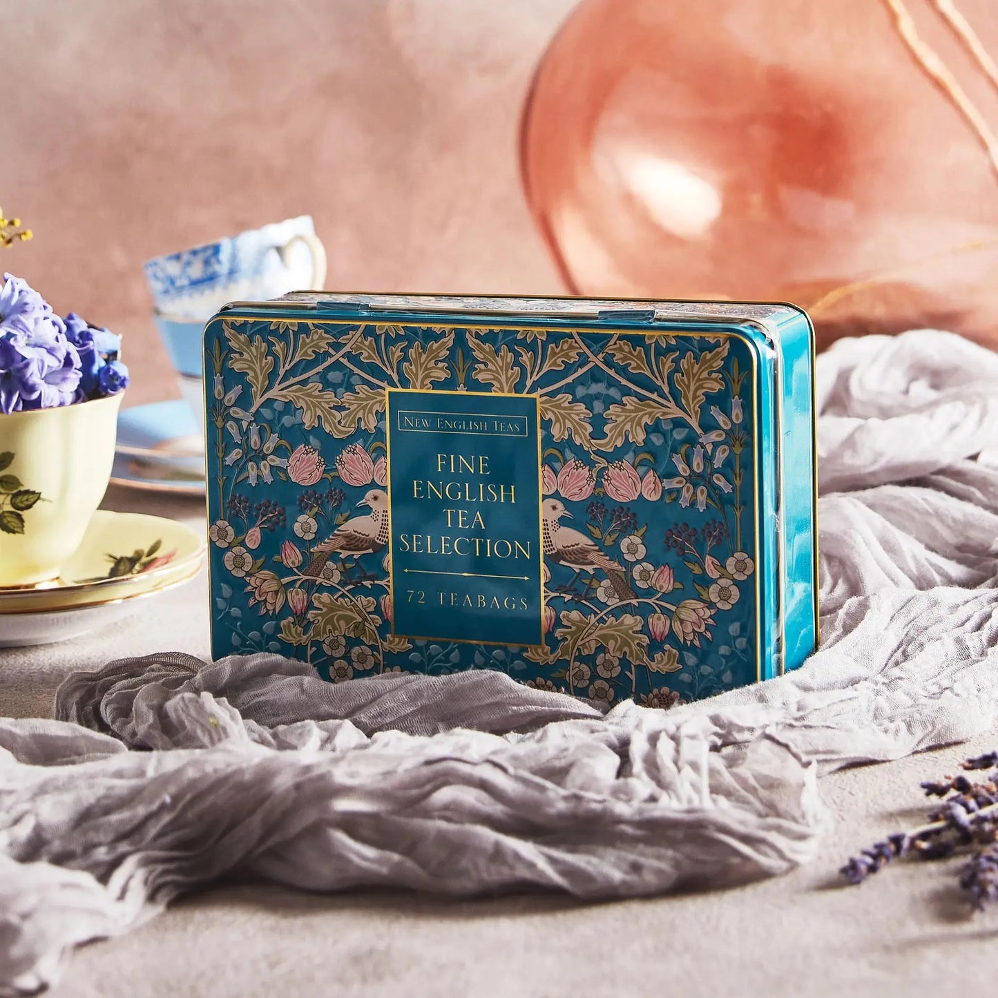 The Song Thrush Tea Selection Tin is a beautifully crafted tea tin, perfect for tea lovers who want to indulge in a variety of flavors. The tin comes in a beautiful teal color that adds a touch of elegance to any kitchen or dining area. The design on