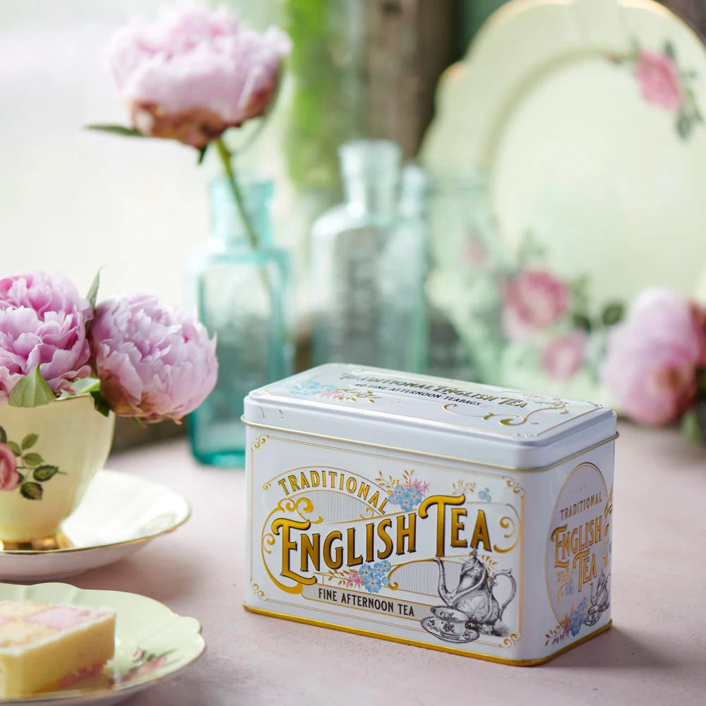 This Ivory Vintage Victorian style tea tin features Victorian tea ware illustrations, gold trimming, embossing throughout and azure blue Forget-Me-Not florals. Forget-Me-Nots became a symbol of love and remembrance for the Victorians and it was durin